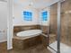 This bathroom includes a large soaking tub and a glass enclosed shower at 5013 Crandon Rd, Fort Mill, SC 29707