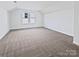 Bright, carpeted bedroom features a large window and neutral walls, offering a serene and spacious atmosphere at 5013 Crandon Rd, Fort Mill, SC 29707