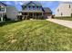 Traditional two-story home featuring manicured lawn, brick facade, covered porch and attached garage at 5013 Crandon Rd, Fort Mill, SC 29707