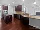 An open concept kitchen boasts stainless steel appliances and granite countertops at 5013 Crandon Rd, Fort Mill, SC 29707