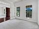 Bright living room with carpet, large windows, and an open doorway at 5013 Crandon Rd, Fort Mill, SC 29707
