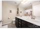 Well-lit bathroom featuring double sinks, dark cabinetry, and neutral-toned walls at 5079 Nighthawk Dr, Fort Mill, SC 29707