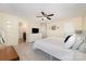 Spacious primary bedroom with neutral carpeting, a ceiling fan and ample natural light, creating a bright and inviting retreat at 5079 Nighthawk Dr, Fort Mill, SC 29707