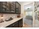 Elegant butler's pantry featuring custom cabinetry, granite countertops, and glass display cabinets at 5079 Nighthawk Dr, Fort Mill, SC 29707
