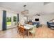 Open-concept dining area with stylish lighting, hardwood floors, and views of the landscaped backyard at 5079 Nighthawk Dr, Fort Mill, SC 29707