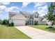 Beautiful two-story home with a well-manicured lawn, long driveway, and classic curb appeal at 5079 Nighthawk Dr, Fort Mill, SC 29707