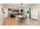 Spacious kitchen featuring stainless steel appliances, a granite island with seating, and an open dining area at 5079 Nighthawk Dr, Fort Mill, SC 29707