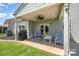 Cozy covered patio with ceiling fan, grill, and outdoor furniture at 5079 Nighthawk Dr, Fort Mill, SC 29707