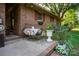 Enjoy outdoor dining on the spacious patio with colorful floral accents and a brick home backdrop at 5329 E Highway 27 Hwy, Iron Station, NC 28080