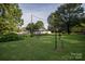 Open backyard with ample green space and fence at 5329 E Highway 27 Hwy, Iron Station, NC 28080