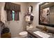 Elegant bathroom with gray walls, granite countertops, decorative fixtures, and a decorative shower curtain at 5329 E Highway 27 Hwy, Iron Station, NC 28080