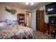Warm bedroom featuring floral bedding, wood paneling, and classic furnishings at 5329 E Highway 27 Hwy, Iron Station, NC 28080