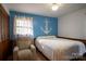 Cozy bedroom with a neutral color scheme and a large anchor decal on the blue accent wall at 5329 E Highway 27 Hwy, Iron Station, NC 28080