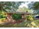 Brick home featuring red shutters and surrounded by lush green lawn and mature trees at 5329 E Highway 27 Hwy, Iron Station, NC 28080