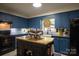 Charming kitchen with blue cabinets, granite countertops, a kitchen island, and stainless steel appliances at 5329 E Highway 27 Hwy, Iron Station, NC 28080