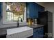 Kitchen featuring blue cabinets, granite countertops, and a stainless steel refrigerator at 5329 E Highway 27 Hwy, Iron Station, NC 28080