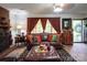 A cozy living room with a leather sofa, decorative curtains, and stylish furniture at 5329 E Highway 27 Hwy, Iron Station, NC 28080