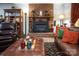 Comfortable living room with a brick fireplace, leather furniture, and stylish decor at 5329 E Highway 27 Hwy, Iron Station, NC 28080