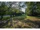 Well-maintained yard with green grass and shade trees, offering a serene outdoor space at 5329 E Highway 27 Hwy, Iron Station, NC 28080