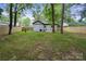 A spacious backyard features a wooden privacy fence and a grassy lawn surrounded by mature trees at 5420 Gwynne Ave # 21, Charlotte, NC 28205
