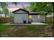 Backyard with white painted brick and a patio, new wooden fence and freshly cut grass at 5420 Gwynne Ave # 21, Charlotte, NC 28205