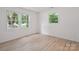 Light-filled bedroom with hardwood floors and large windows offering a peaceful view at 5420 Gwynne Ave # 21, Charlotte, NC 28205