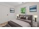 Bright bedroom features a neutral color palette, light wood floors, and a comfortable queen-sized bed at 5420 Gwynne Ave # 21, Charlotte, NC 28205