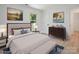 Cozy staged bedroom featuring a tufted headboard, bench, area rug and a chest of drawers at 5420 Gwynne Ave # 21, Charlotte, NC 28205