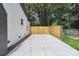 Concrete driveway with new wooden fence leading to the renovated home at 5420 Gwynne Ave # 21, Charlotte, NC 28205