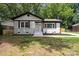 Beautiful exterior of a painted brick home with black and white trim, wooden accents, and manicured front yard at 5420 Gwynne Ave # 21, Charlotte, NC 28205