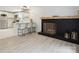 Open-concept living room featuring a modern fireplace, hardwood floors, and a kitchen with a breakfast bar at 5420 Gwynne Ave # 21, Charlotte, NC 28205