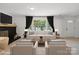 Staged living room with a cozy fireplace, hardwood floors, a large window and comfortable seating at 5420 Gwynne Ave # 21, Charlotte, NC 28205
