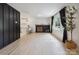 Bright living room with modern fireplace, hardwood floors, large windows, and open view to the kitchen at 5420 Gwynne Ave # 21, Charlotte, NC 28205
