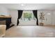 Bright living room with modern fireplace, hardwood floors, and large window to a lush front yard at 5420 Gwynne Ave # 21, Charlotte, NC 28205