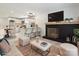 Staged living room with a fireplace, hardwood floors, and a kitchen with a breakfast bar at 5420 Gwynne Ave # 21, Charlotte, NC 28205