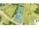 Aerial shot of a sprawling property, showcasing the house, manicured lawn, and tree-lined boundaries at 594 Patterson Farm Rd, Mooresville, NC 28115