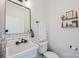Stylish powder bathroom with a white sink, modern fixtures and decor at 594 Patterson Farm Rd, Mooresville, NC 28115