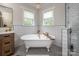 Serene bathroom showcasing a clawfoot tub, elegant chandelier, and modern fixtures for ultimate relaxation at 594 Patterson Farm Rd, Mooresville, NC 28115