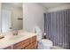 Bathroom featuring a wood vanity, large mirror, and a patterned shower curtain at 594 Patterson Farm Rd, Mooresville, NC 28115