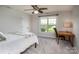 Simple yet comfortable bedroom includes natural light, a cozy bed, and dedicated desk workspace at 594 Patterson Farm Rd, Mooresville, NC 28115
