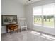 Bright bedroom with a rocking chair and a large window overlooking the outside view at 594 Patterson Farm Rd, Mooresville, NC 28115