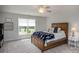 Cozy bedroom with a ceiling fan, wooden bed frame, and a window providing natural light at 594 Patterson Farm Rd, Mooresville, NC 28115