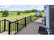 Wood deck with black metal railings overlooking a lush green field and barn at 594 Patterson Farm Rd, Mooresville, NC 28115
