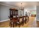 Inviting dining room with a large table, chandelier, hardwood floors, and view of the kitchen at 594 Patterson Farm Rd, Mooresville, NC 28115