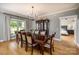 Inviting dining room with a large table, chandelier, hardwood floors, and cabinet display at 594 Patterson Farm Rd, Mooresville, NC 28115