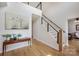 Bright entryway featuring hardwood floors, modern staircase with black metal railings and stylish décor at 594 Patterson Farm Rd, Mooresville, NC 28115