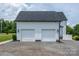 Detached two-car garage with clean white doors, dark roof, and complemented by manicured landscaping at 594 Patterson Farm Rd, Mooresville, NC 28115