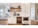Stylish kitchen with custom white cabinetry, stainless steel appliances, beverage center, and under-cabinet microwave at 594 Patterson Farm Rd, Mooresville, NC 28115