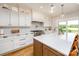 Modern kitchen featuring a large island, white cabinets, quartz countertops, and stainless steel appliances at 594 Patterson Farm Rd, Mooresville, NC 28115