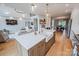 Bright, open kitchen featuring an island with white countertops, pendant lighting, and stainless steel appliances at 594 Patterson Farm Rd, Mooresville, NC 28115
